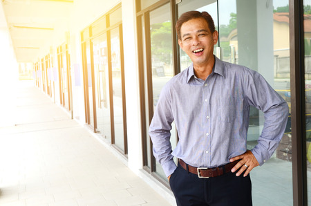 Portrait of a cheerful middle aged asian businessmanの写真素材