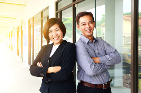 Cheerful middle aged asian businessman and businesswomanの写真素材