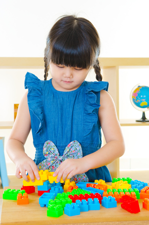 Asian kid playing building blockの写真素材