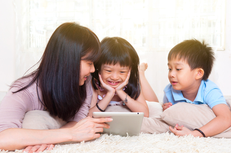 Asian family using tablet computerの写真素材