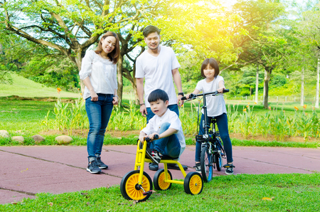 Asian kids enjoyed cycling at the parkの写真素材