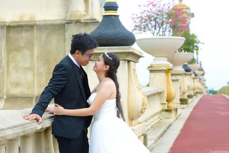 Asian bride and groom looking at each otherの写真素材