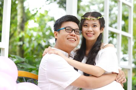 Beautiful asian adults in love hug each otherの写真素材