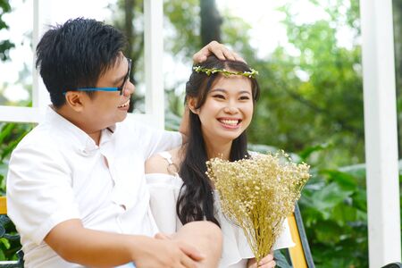 Lovely asian young couple laugh happilyの写真素材