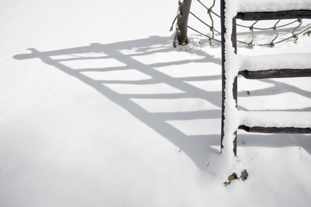 Monkey bars shadow on the snow.の写真素材