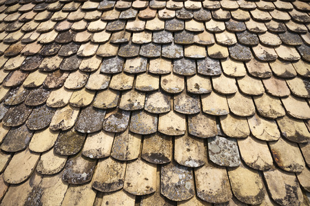 Lot of old fashioned tiles on a roof from above for patternの写真素材