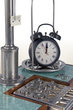Traditional old style pharmacy scale with small weights and large clock, macro