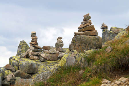 Zen rocks stack in high mountains with clouds in background