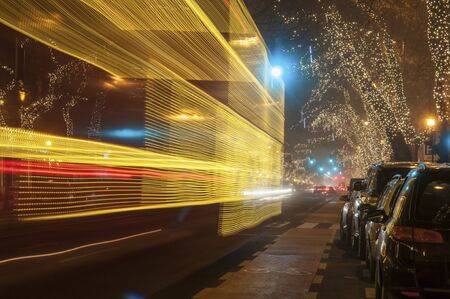 Light decorated bus motion blur at Christmas night