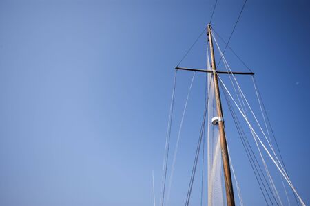 Old style ship's mast from below with clear blue skyの写真素材