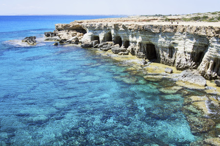 Sea caves in the high cliffs at south-east corner of Cyprusの写真素材