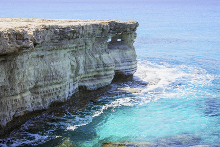 Sea caves in the high cliffs at south-east corner of Cyprusの写真素材