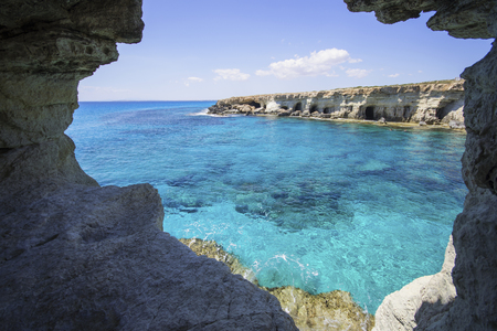 Sea caves in the high cliffs at south-east corner of Cyprusの写真素材