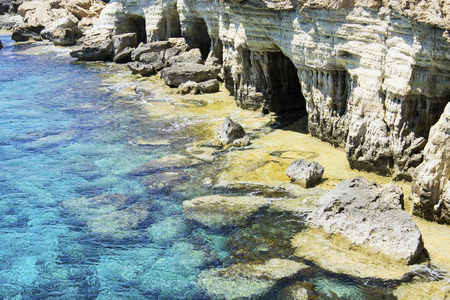 Sea caves in the high cliffs at south-east corner of Cyprusの写真素材