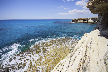 Sea caves in the high cliffs at south-east corner of Cyprusの写真素材