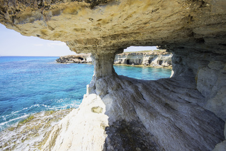 Sea caves in the high cliffs at south-east corner of Cyprusの写真素材