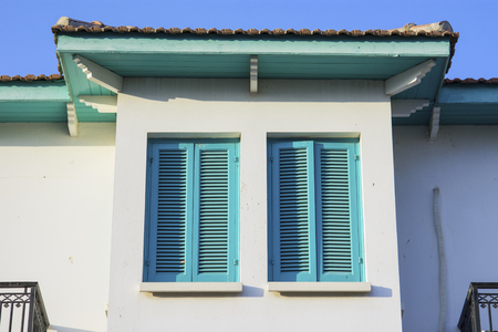 Sunny and colorful house detail with windowsの写真素材