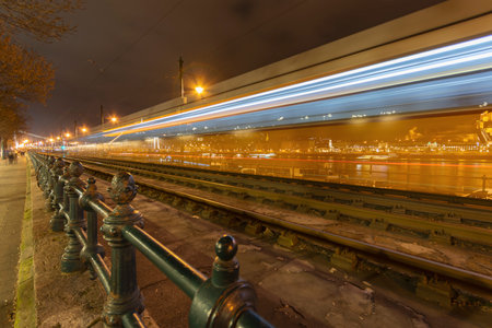 Budapest Danube riverside with lights and motion blurred yellow tram at night, Hungaryの写真素材