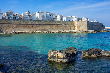 The seaward wall of Monopoli, with an empty bay and rocksの写真素材