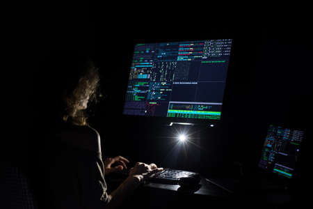 Hacker coding at night cybersecurity concept