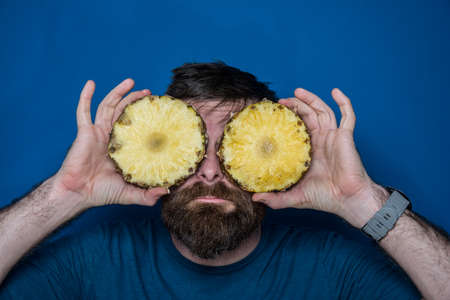 Young man  playing guitar with blue backgroundの写真素材