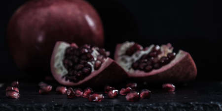 Fresh Pomegranate in black texture background