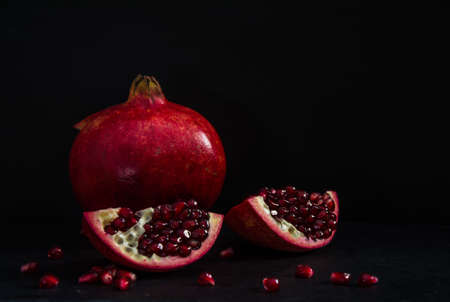 Fresh Pomegranate in black texture backgroundの写真素材