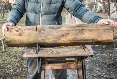 Carpenter's Hands Cutting Wood With Tablesawの写真素材
