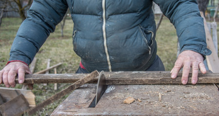 Carpenter's Hands Cutting Wood With Tablesaw