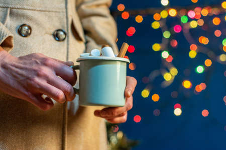 Christmas cup in female hands,の写真素材