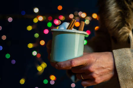 Christmas cup in female hands,の写真素材
