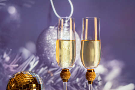 Champagne glasses on sparkling background. Two champagne glasses ready to bring in the New Year.の写真素材