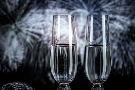 Champagne glasses on sparkling background. Two champagne glasses ready to bring in the New Year.の写真素材