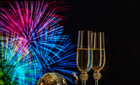 Champagne glasses on sparkling background. Two champagne glasses ready to bring in the New Year.の写真素材