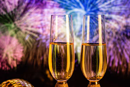 Champagne glasses on sparkling background. Two champagne glasses ready to bring in the New Year.の写真素材