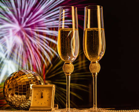 Champagne glasses on sparkling background. Two champagne glasses ready to bring in the New Year.の写真素材