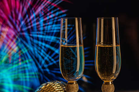 Champagne glasses on sparkling background. Two champagne glasses ready to bring in the New Year.の写真素材