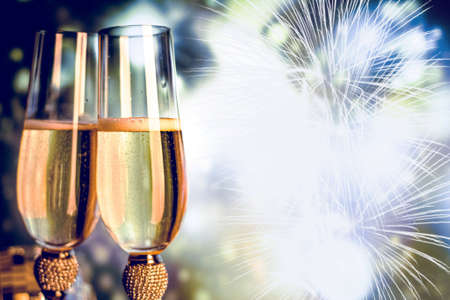 Champagne glasses on sparkling background. Two champagne glasses ready to bring in the New Year.の写真素材