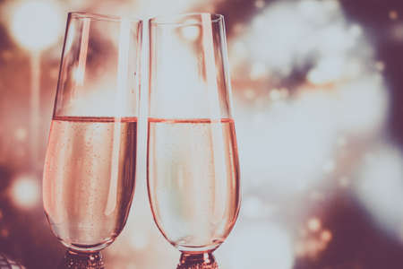 Champagne glasses on sparkling background. Two champagne glasses ready to bring in the New Year.の写真素材
