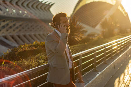 The manager is holding a phone in his hands. Portrait of a young entrepreneur.A new business center...