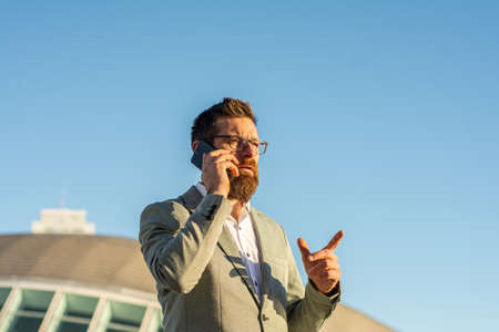 Mobile lifestyle. New technology. Handsome man with cell phone outdoors. Business communication....