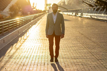 Male manager walking on the road. Young business man portrait.の写真素材