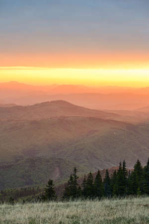 Colorfully sunrise over the mountains seen from high altitude .Scenic view of silhouette mountains...