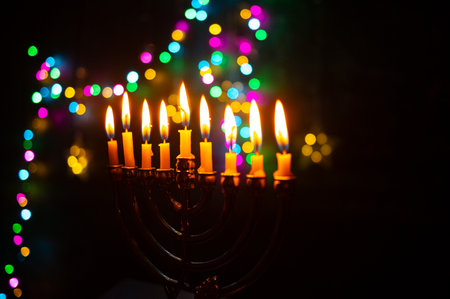 A glowing Hanukkah menorah with burning candles surrounded by soft warm lights. Perfect for...