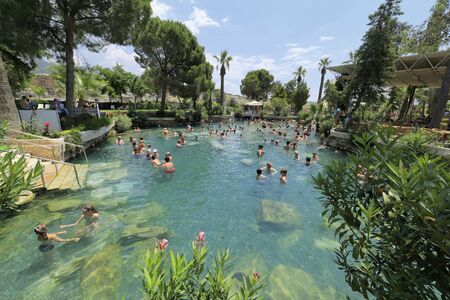 PAMUKKALE, TURKEY - JULY 9, 2015: A lot of peaople visit the Cleopatra bath in Hierapolis.のeditorial素材