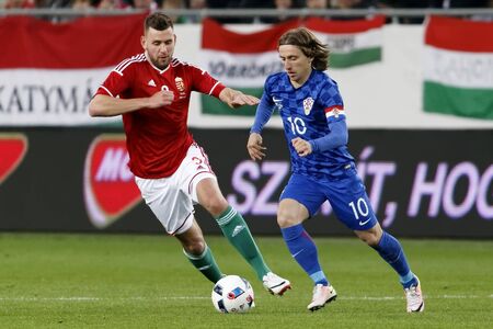 BUDAPEST, HUNGARY - MARCH 26, 2016: Hungarian Adam Szalai (l) tries to follow Croatian Luka Modric during Hungary vs. Croatia international friendly football match in Groupama Arena.のeditorial素材