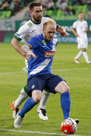 BUDAPEST, HUNGARY - APRIL 16, 2016: Daniel Bode of Ferencvaros (l) duels for the ball with Patrik Poor of MTK Budapest during Ferencvaros - MTK Budapest OTP Bank League football match at Groupama Arena.のeditorial素材