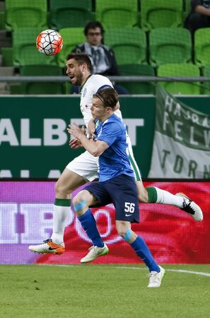 BUDAPEST, HUNGARY - APRIL 16, 2016: Daniel Bode of Ferencvaros (l) battles for the ball in the air with Daniel Gera of MTK Budapest during Ferencvaros - MTK Budapest OTP Bank League football match at Groupama Arena.のeditorial素材