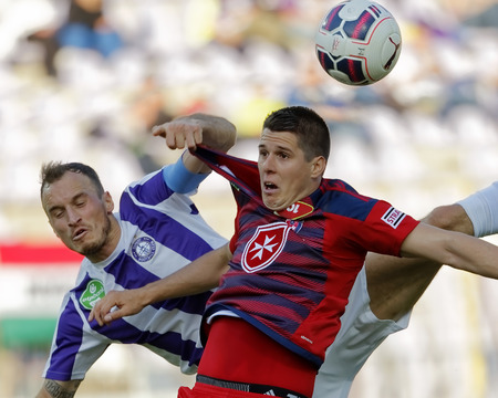 BUDAPEST, HUNGARY - APRIL 30, 2016: Robert Litauszki of Ujpest (l) battles for the ball in the air with Patrik Tischler of Videoton during Ujpest - Videoton OTP Bank League football match at Szusza Stadium.のeditorial素材
