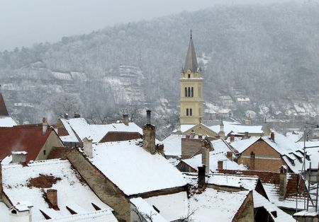 quiet mountain village and church tower in winterの写真素材